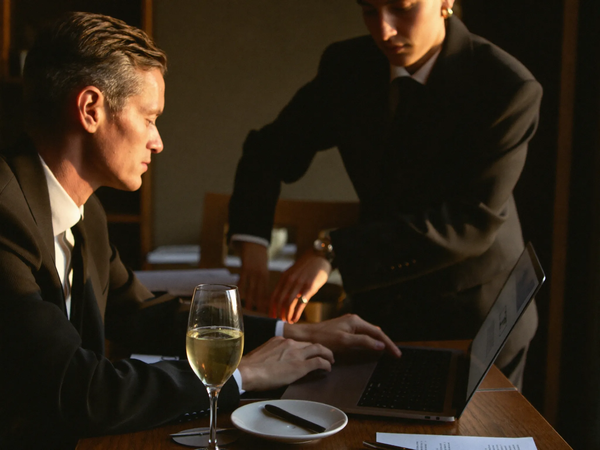 Business owner and consultant working together on a laptop